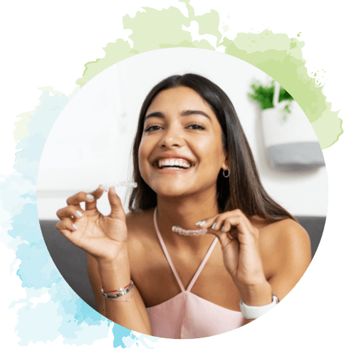 A girl holding her Invisalign clear aligners.
