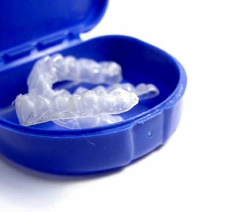 Image of invisalign aligners in a storage carrying case. 