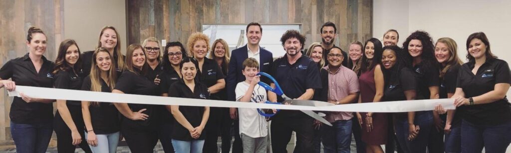 Dr. Feldman, Dr. Cetta, and the Blue Wave team posing for a photo due to the opening of the East Bradenton orthodontic office.