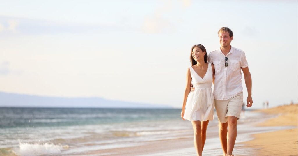 couple walks on beach and talks about how to clean retainers