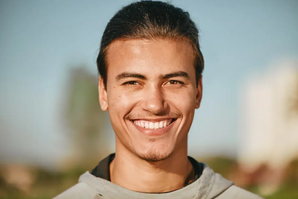 Young guy smiling with straight teeth